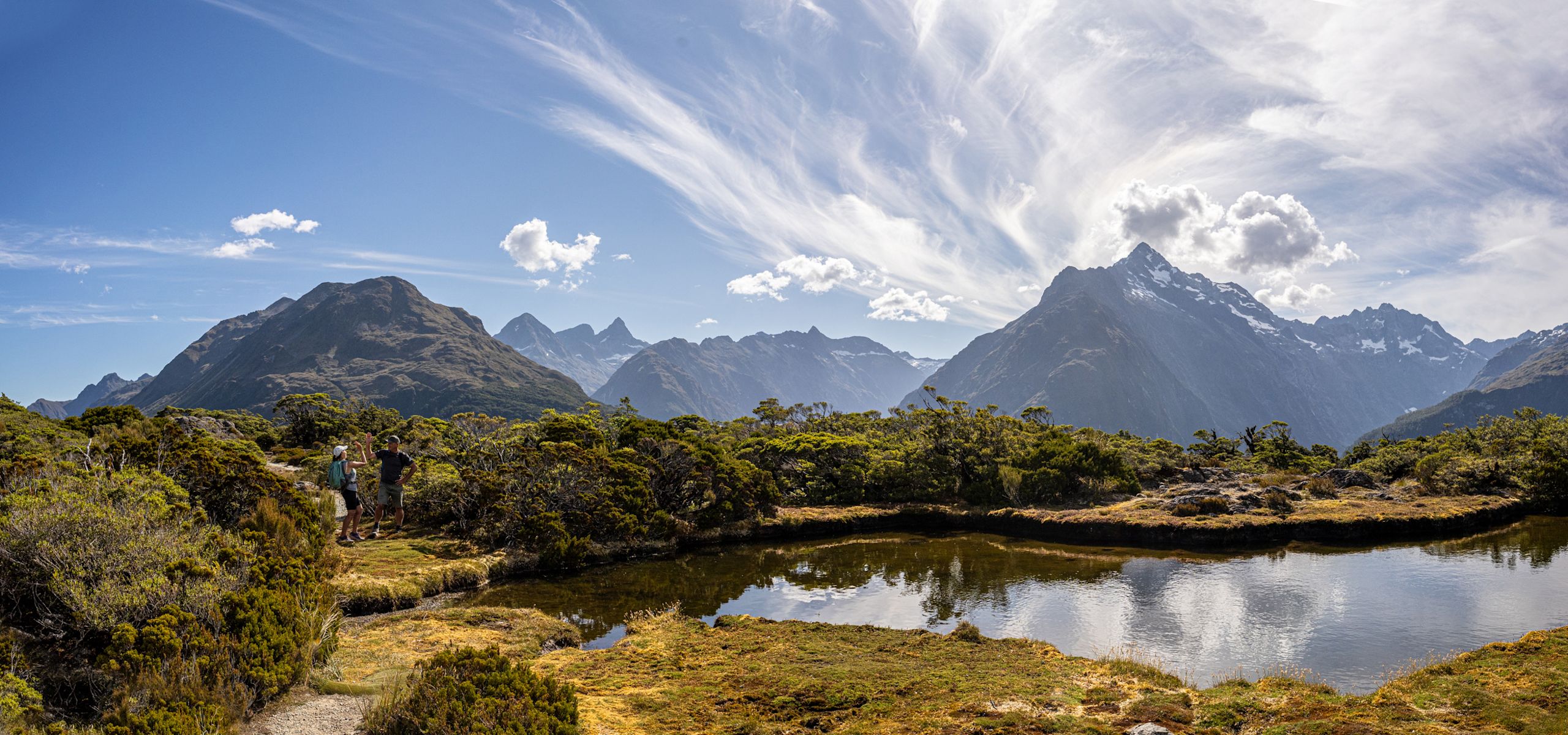 Guest hiking on the Routeburn Track Great Walk of New Zealand at Key Summit