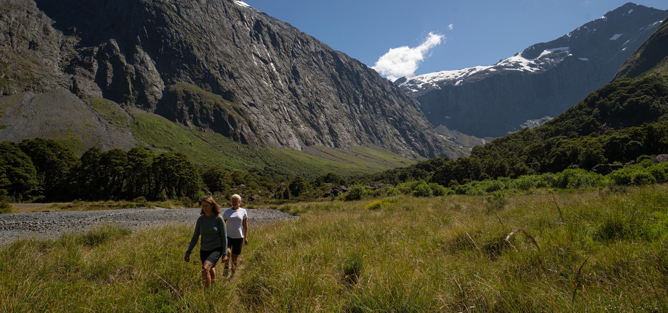 Guest hiking on the Routeburn Track Great Walk of New Zealand at Key Summit