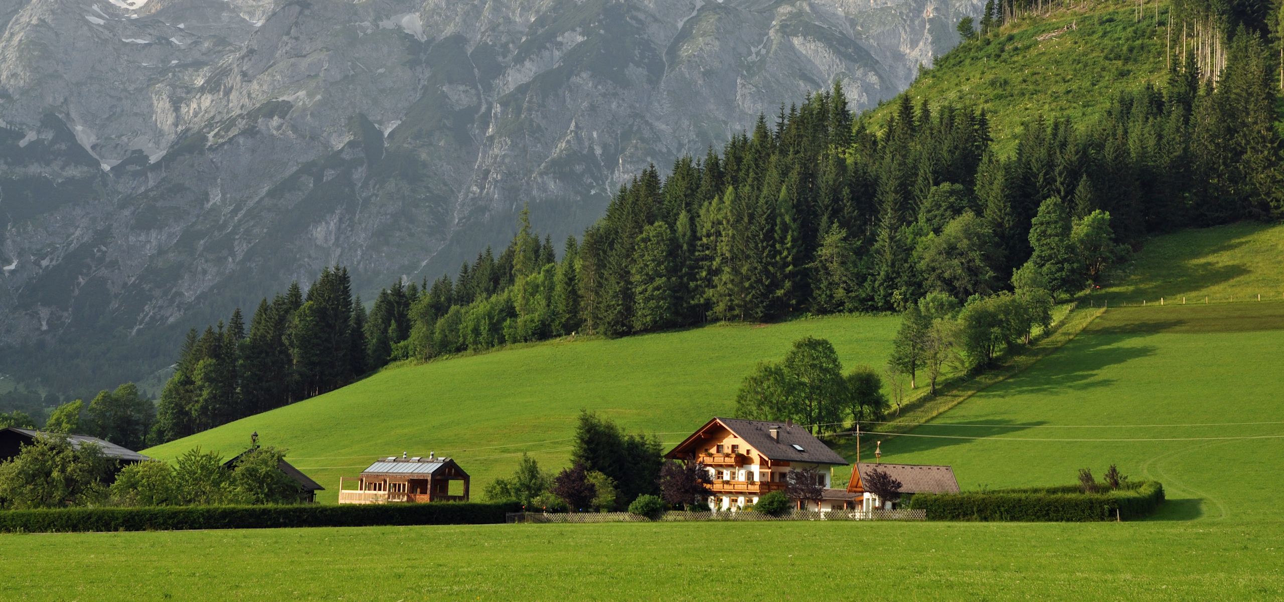 View of Austrian Alps with chalet in the foreground