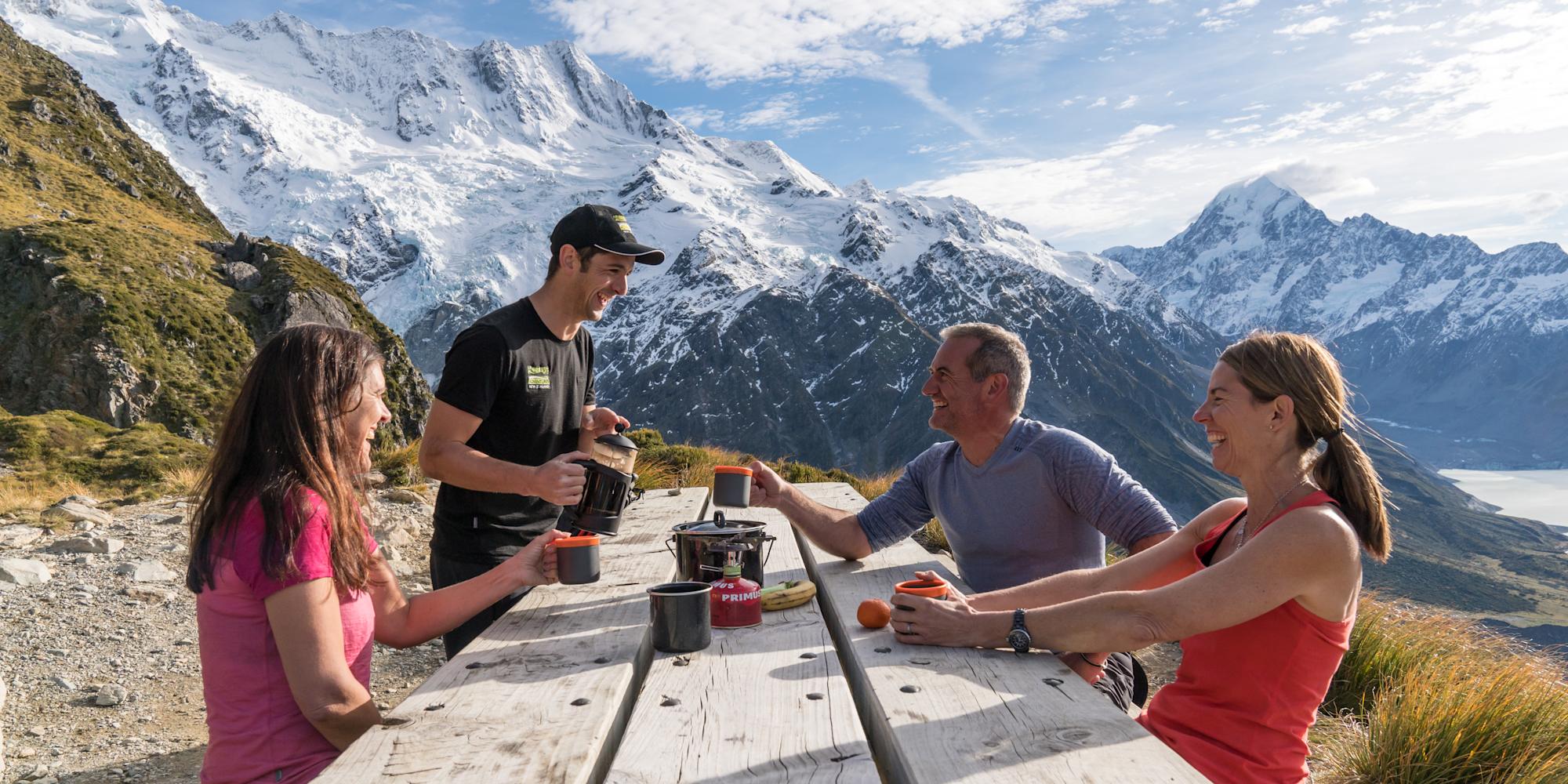 Guests with their Active Adventures guide having a break on a hike in Aoraki Mount Cook National Park