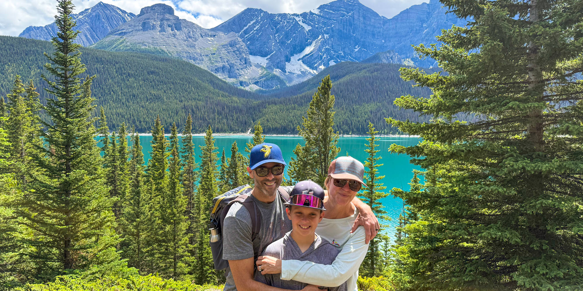 A mom, dad and their son stop of a photo on their Banff & Jasper Family vacation
