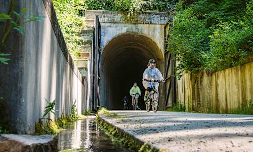 Guests cycling through St. Paul Pass Tunnel