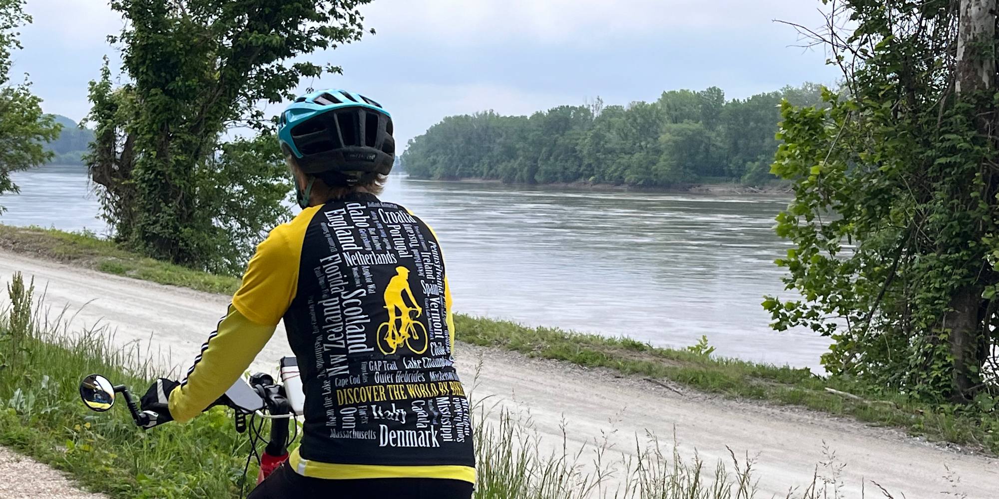 Guest cycling by river on Katy Trail 